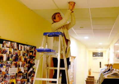 Bridget Walsh changing lightbulbs at KMC Long Island